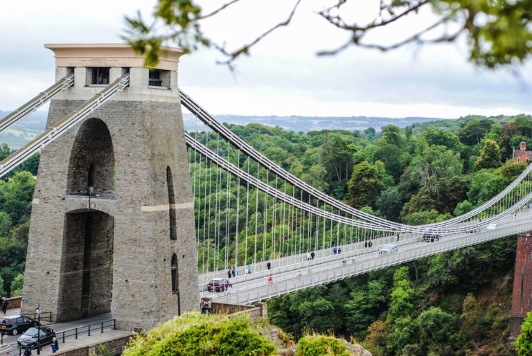 An image of Clifton Suspension Bridge through the trees from the observatory above.