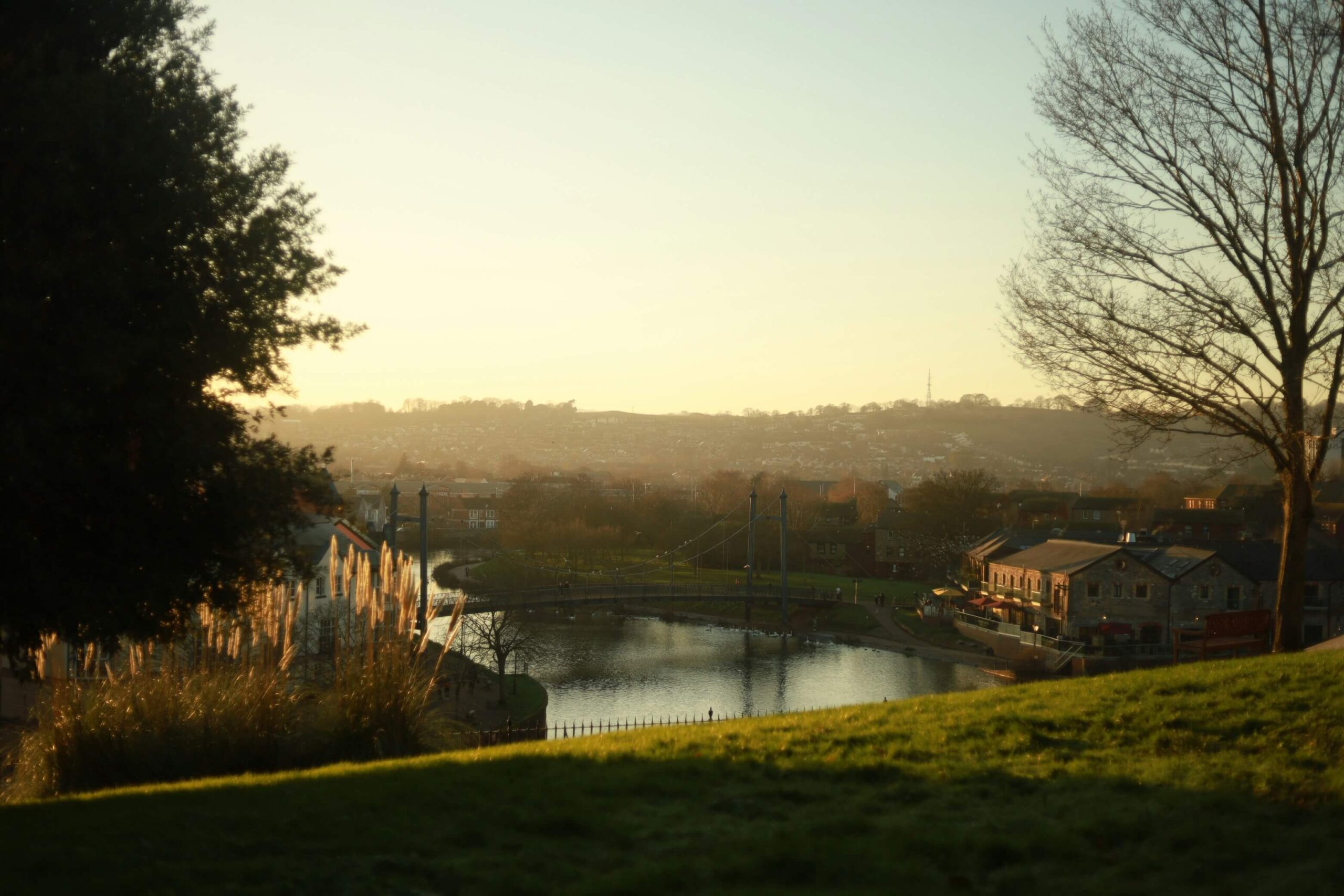 An image of Exeter in the evening as the sun sets above the harbour.