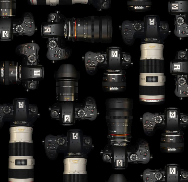 An image of film cameras and lenses on a table.