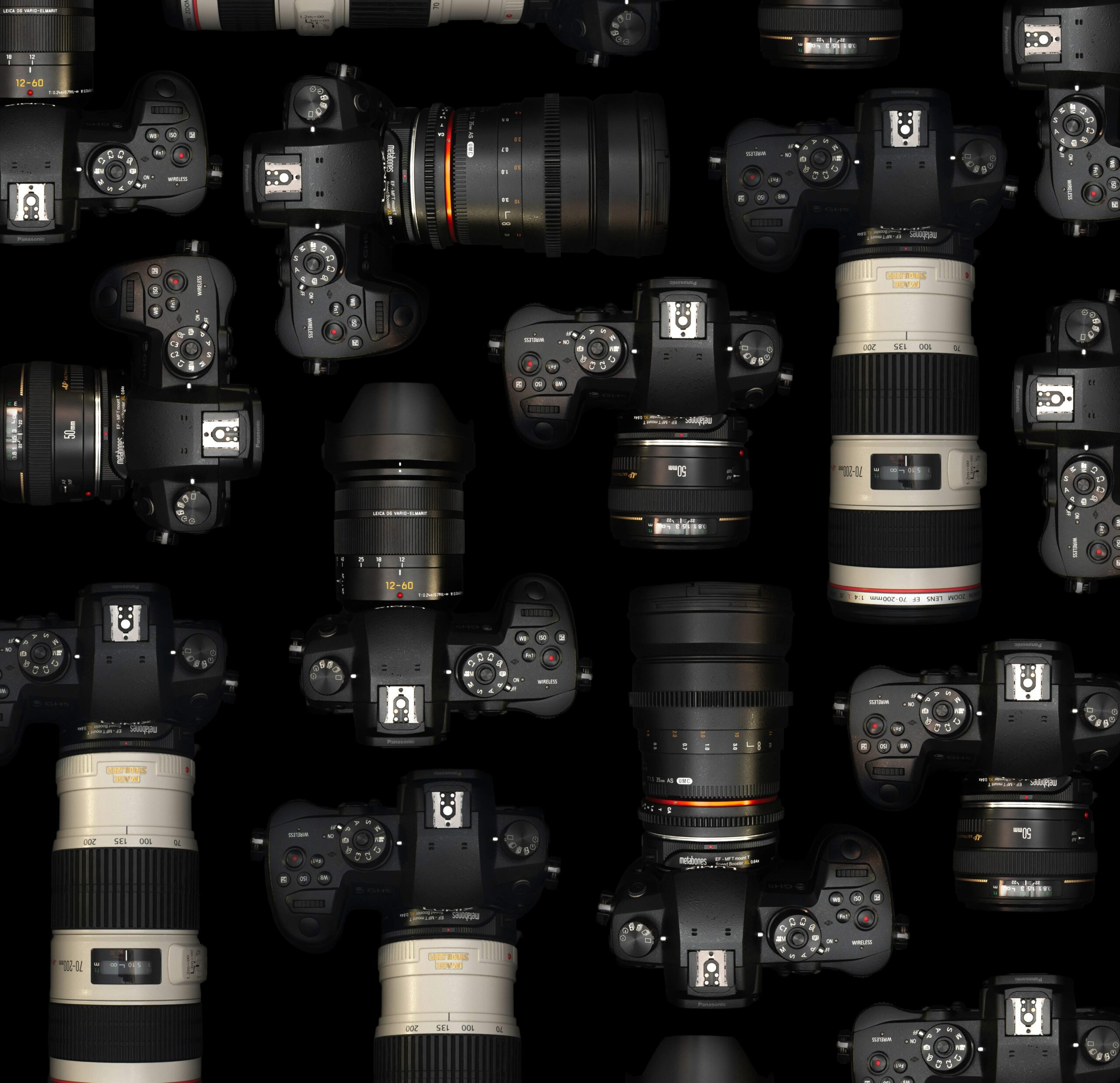 An image of film cameras and lenses on a table.