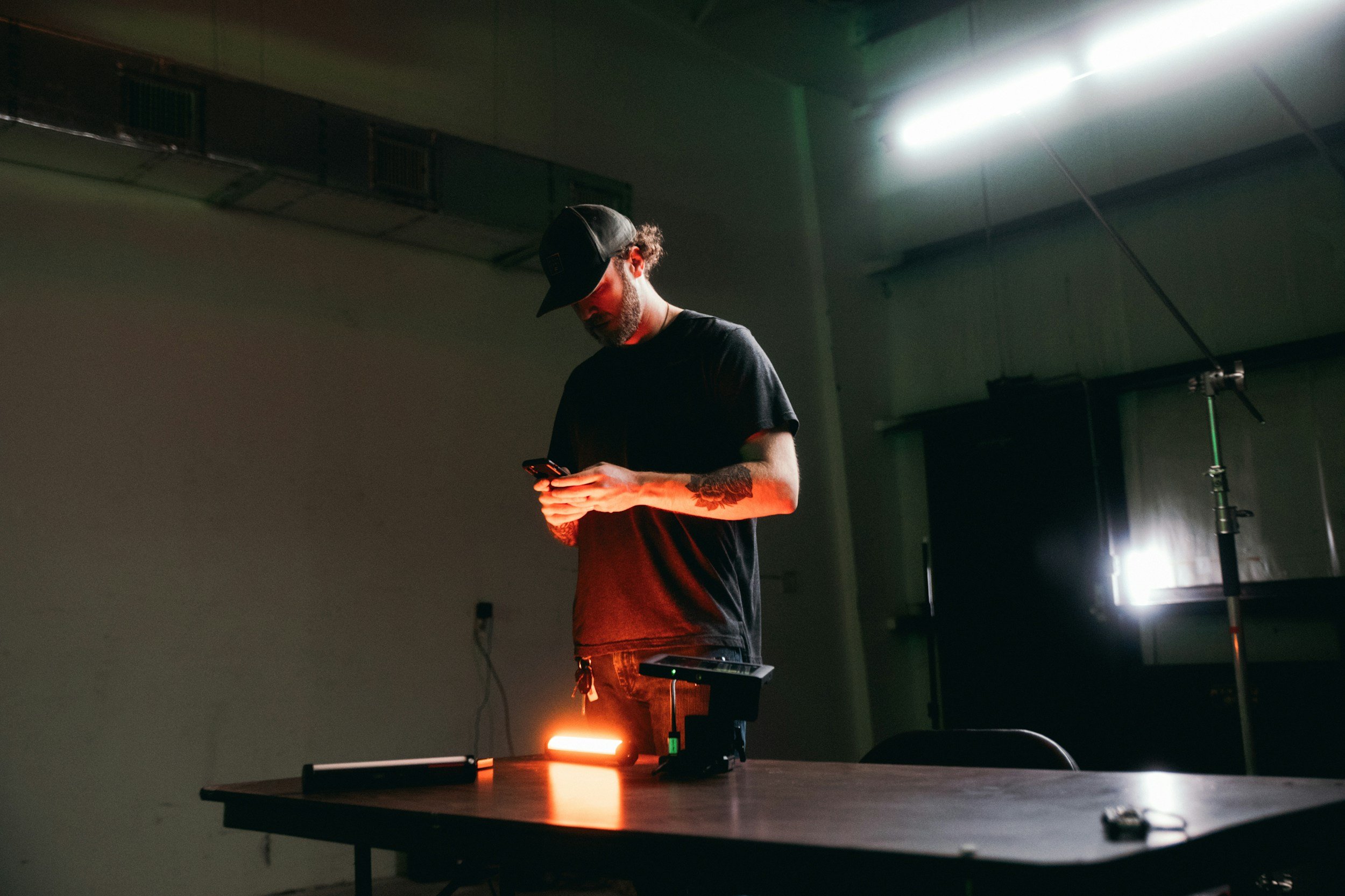 A lighting camera operator setting up kit on a kit table.