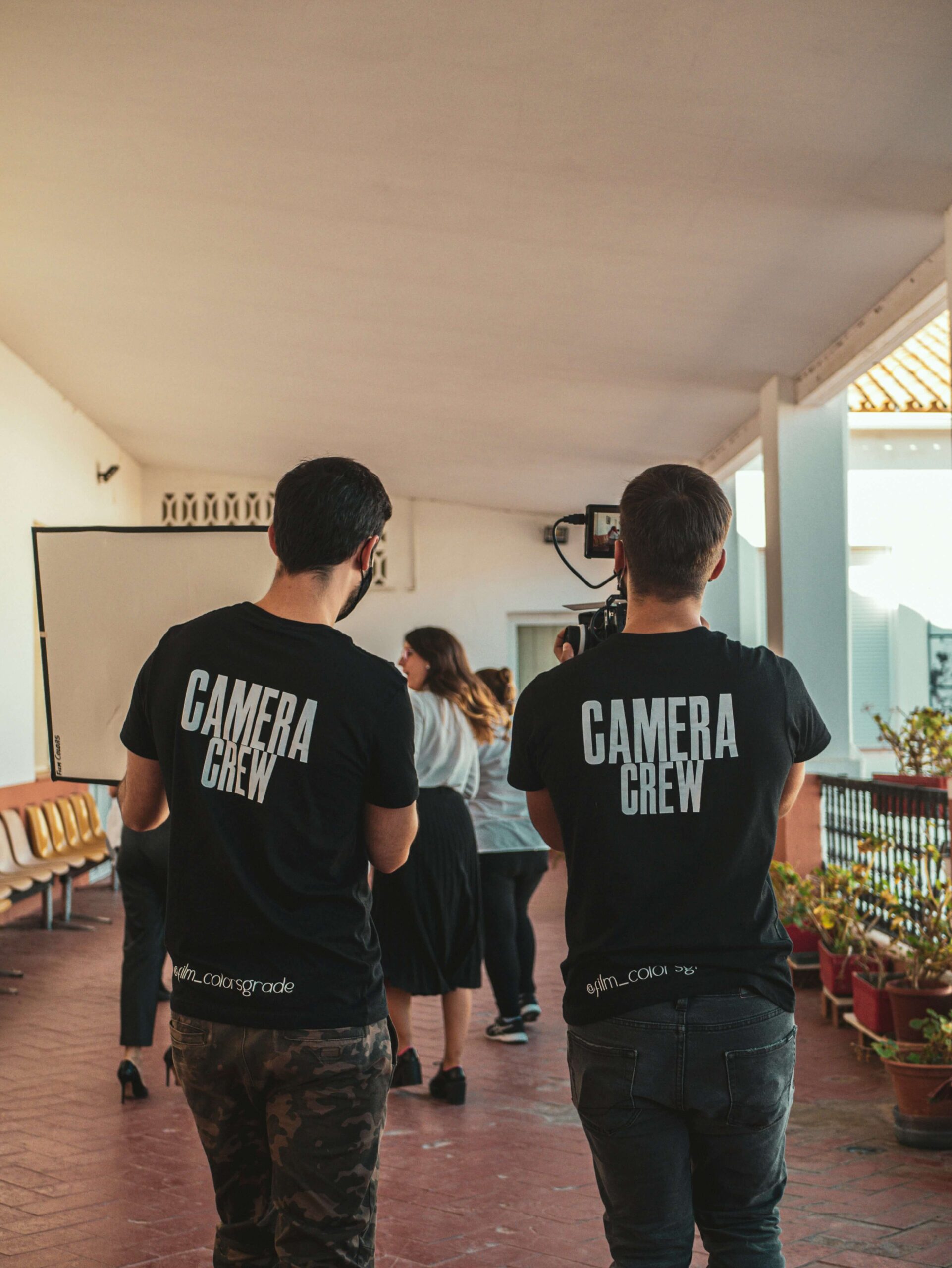 Oliver Couch, director and co-founder of Here Now Films. He's a camera man holding a camera.