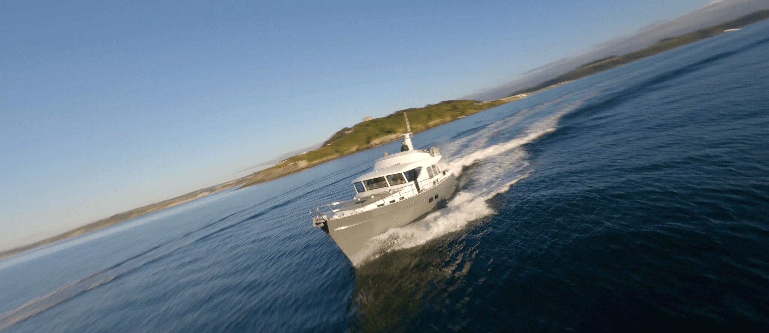 An FPV drone shot of a Cockwells Classic Yacht in Falmouth Harbour.