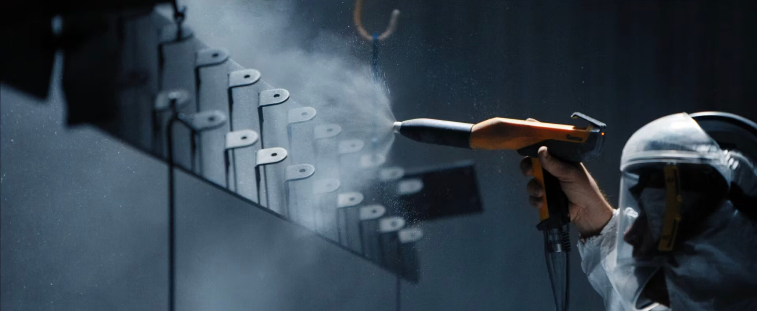 An image of an Alber eployee spray painting a piece of furniture.