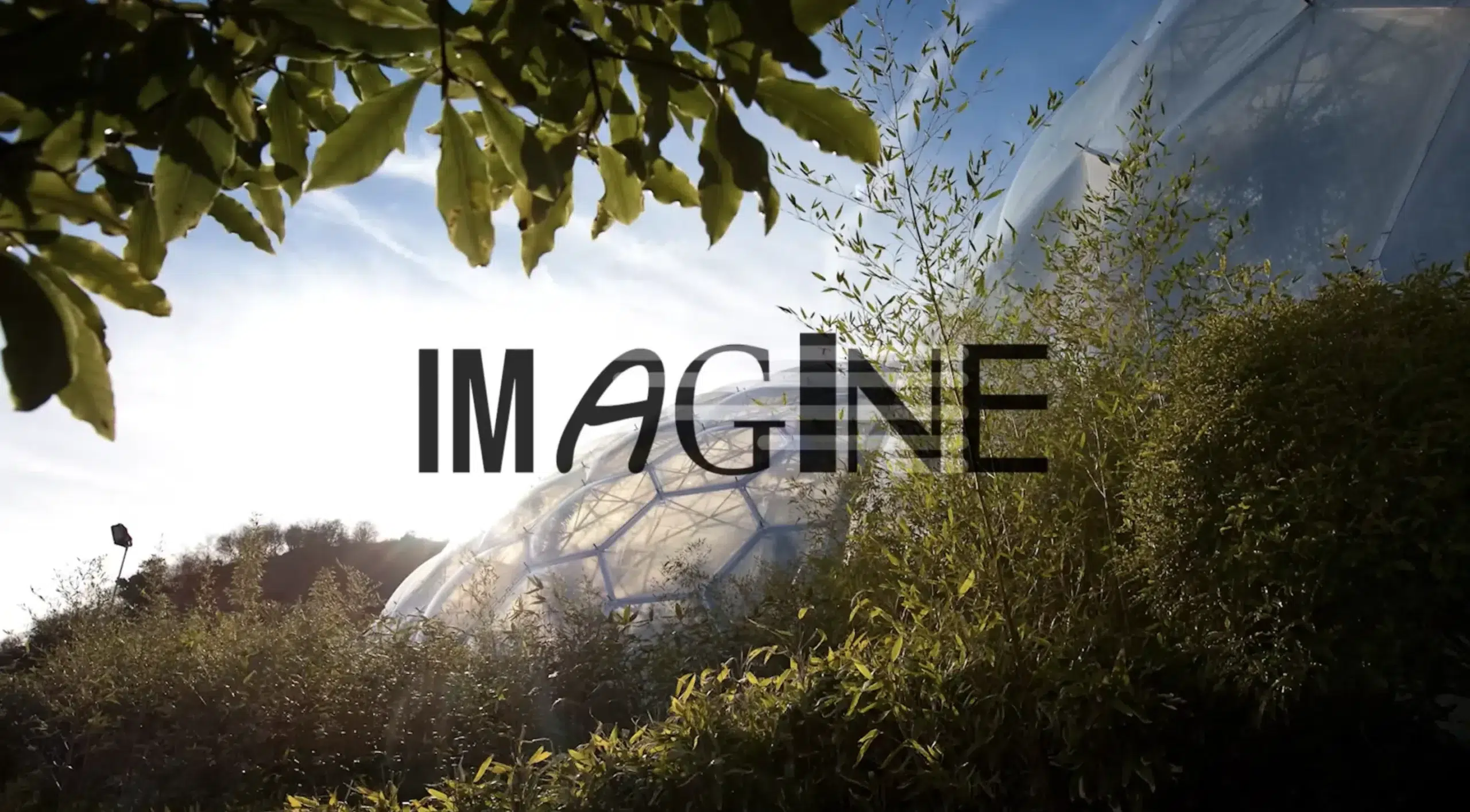 An image of the eden project biomes with the words "imagine" on screen.