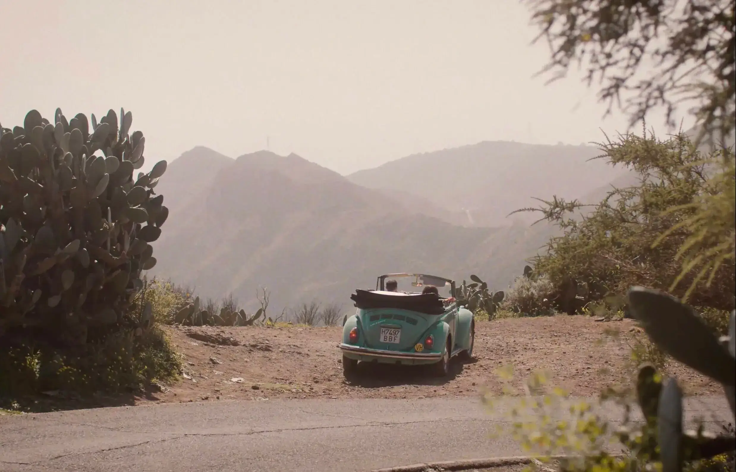 An image of a old fashioned Blue Beetle car parked at a view point in Tenerife.