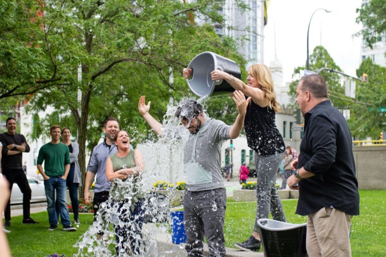 An image of someone doing the ALS ice challenge with a crowd around them.