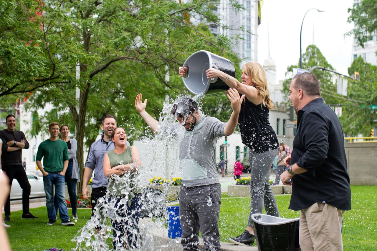 An image of someone doing the ALS ice challenge with a crowd around them.