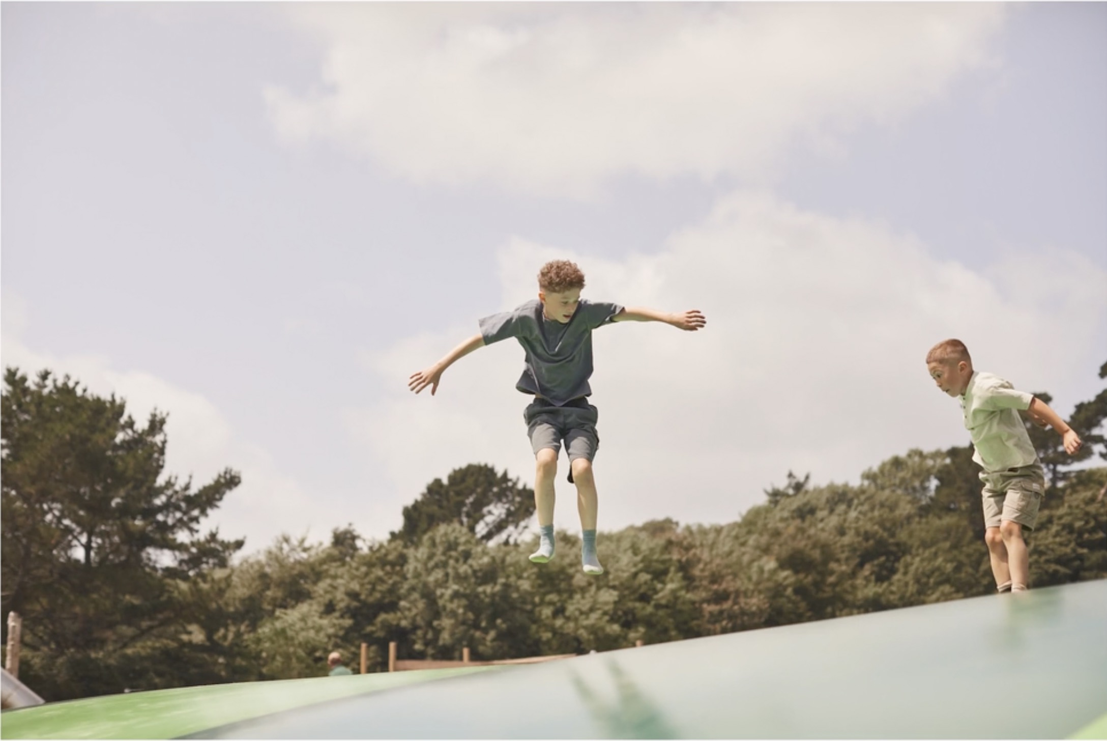 An image of a child jumping up and down on the Heligan play pillow.