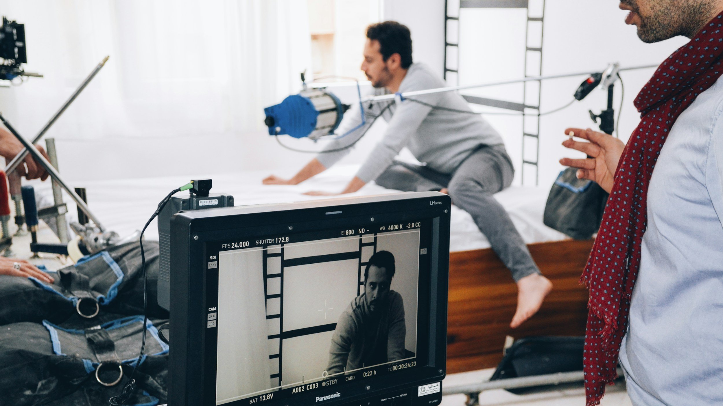 An art director on set working on a white back drop.