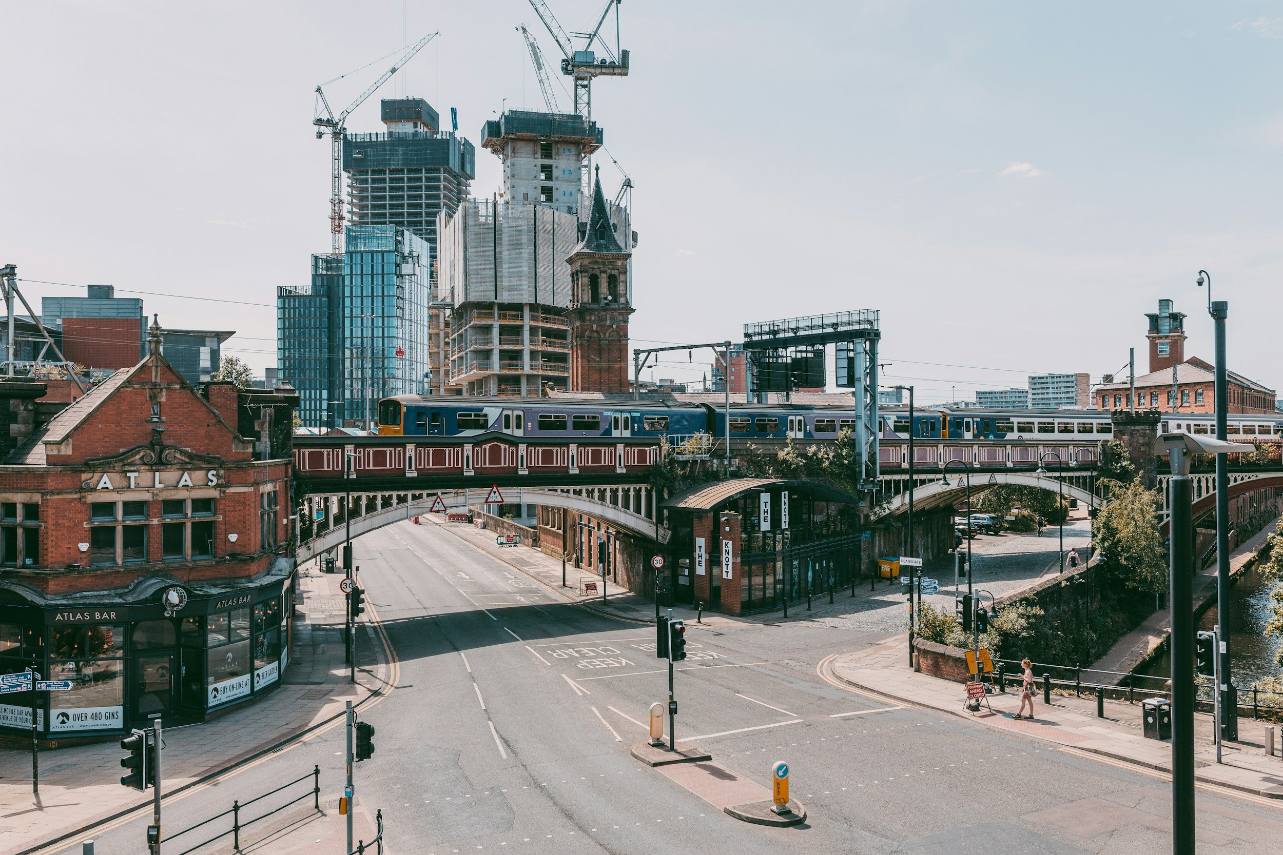 A photo of Manchester's skyline with beautiful bridges in the foreground