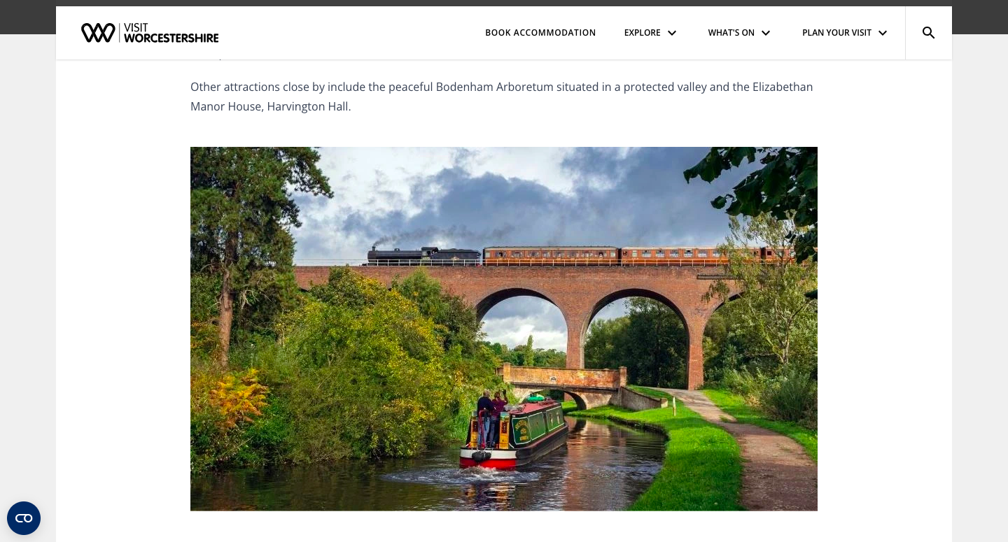 A screen shot of Kidderminster's landing page. A train passes over a bridge and a canal boat floats beneath.