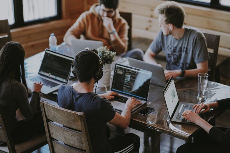 An image of a companies in-house creative video production team sitting around a table discussing an idea.