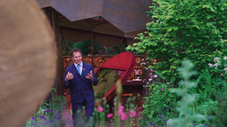 An image of Monty Don walking in the Royal Entomological Garden as he present for Chelsea Flower Show.