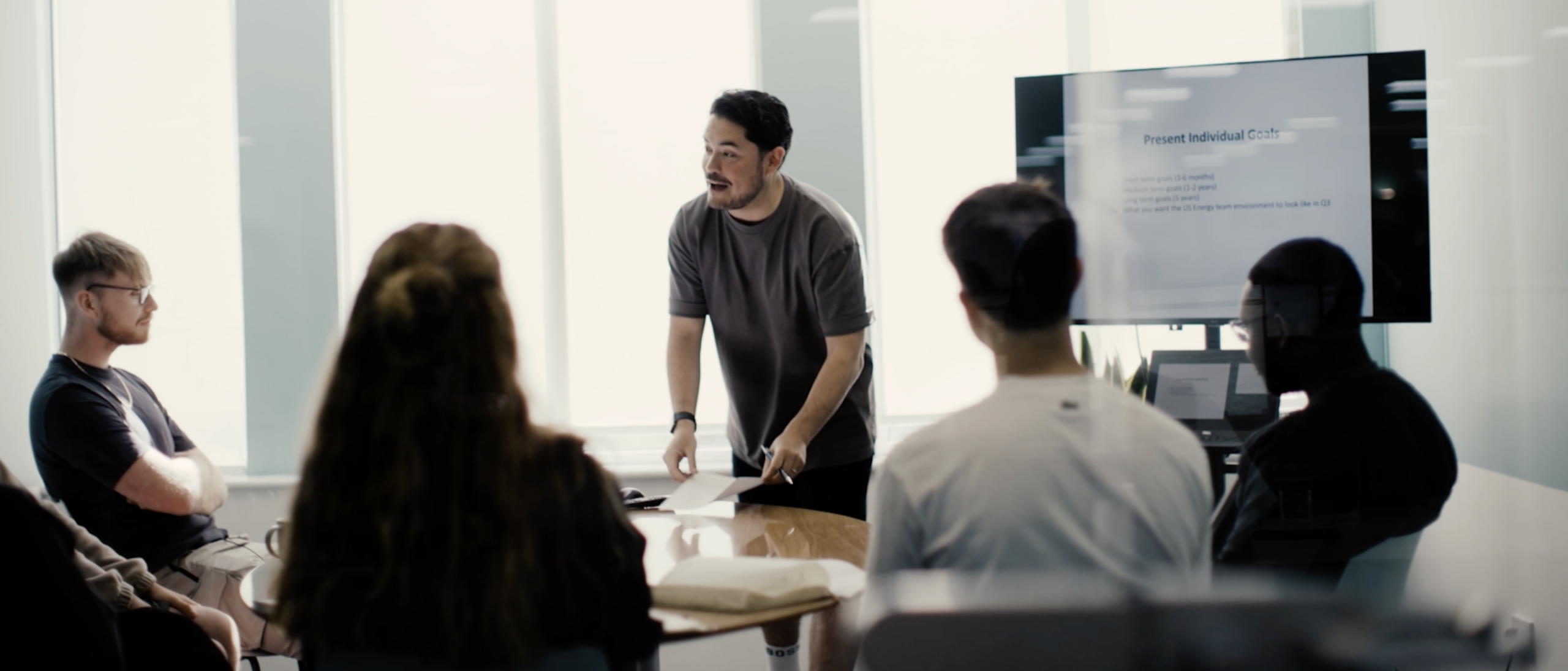 An image of a Rise Recruitment team delivering a workshop around a table for the recruitment video production.